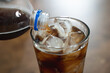 © Pormezz - close up shot. person pouring soda to glass and many soda pop