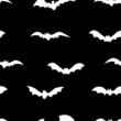 White silhouettes of bats seamless pattern on black background. Halloween design for baby clothes, bedding, textiles, print, wallpaper.