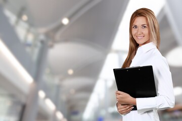 Portrait of cheerful warehouse woman worker using tablet checking information