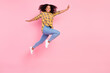 © deagreez - Photo of cheerful inspired lady jump have fun wear plaid shirt jeans sneakers isolated pink color background