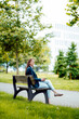 © Westend61 - Young businesswoman sitting on bench at park