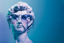 Gypsum Copy Of The Sculpture David Michelangelo In Sunglasses On Blue Background