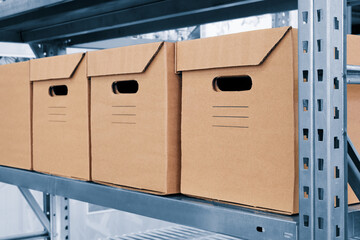 Fototapete - warehouse interior with cardboard boxes on shelves close up