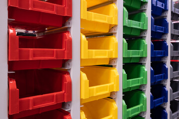 Fototapete - rows of multicolored plastic boxes for components
