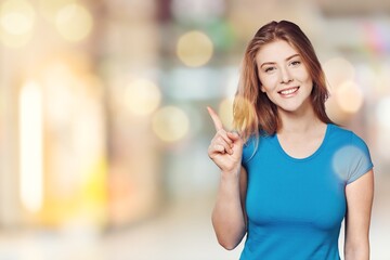 Canvas Print - Happy lady smiling, pointing and looking with surprised face, standing