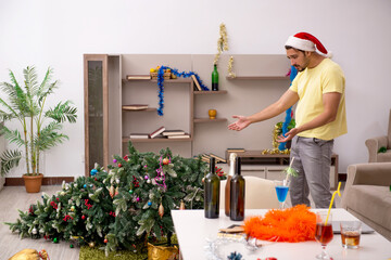 Poster - Young man cleaning the apartment after Christmas party