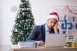© Elnur - Young male employee celebrating Christmas at workplace