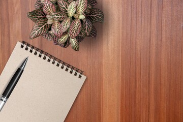 Wall Mural - A desk with blank notepad, flower and pen