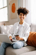 © (JLco) Julia Amaral - Happy young woman enjoying an online sale at home