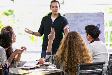 Selective focus on woman's hand raising for asking question or giving creative ideas to caucasian male colleague about marketing strategy presentation in modern meeting room at comfortable office.