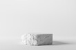 © oatawa - White stone rough plate object display podium on grey background. 3d rendering