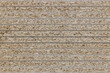 The texture of a stack of OSB sheets in a supermarket. Side view. Abstract background.