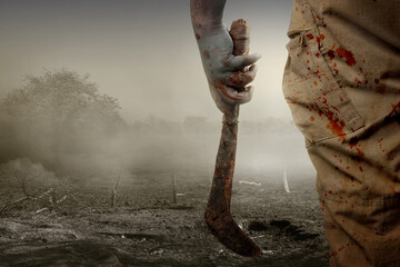 Canvas Print - Scary zombie with blood and wound on his body holding sickle standing