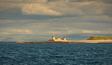 Beautiful Seascape Scenery With Lighthouse Under Dramatic Cloudy Skies At Aran Islands At West Of Ireland 