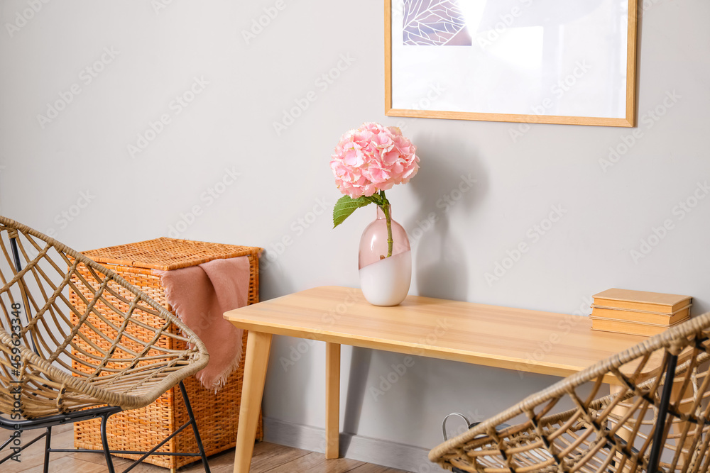 Vase with hydrangea flowers on table in living room