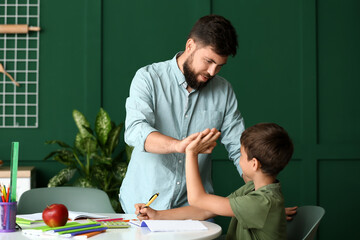 Poster - Little boy with his father doing lessons at home