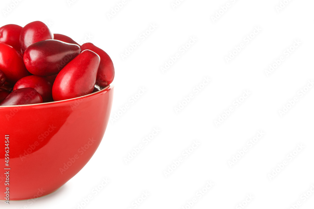 Bowl with ripe dogwood berries on white background, closeup