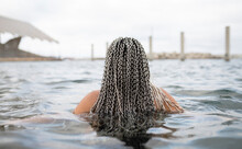 Young Woman With Braided Hair In Water During Weekend