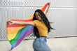 © Westend61 - Carefree lesbian woman dancing with pride flag