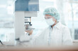 © Westend61 - Female pharmacist with protective face mask researching on medicine at laboratory