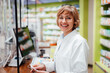 © Westend61 - Happy female pharmacist standing in medical store