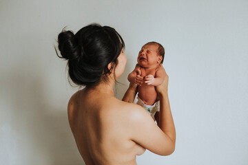 Wall Mural - mother holding her infant baby