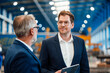 © Westend61 - Male managing director discussing over digital tablet with colleague in factory