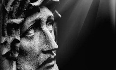 Fototapete - Jesus Christ against dark background. Ancient statue. Horizontal image.