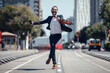 © Westend61 - Businessman dancing on road during sunny day