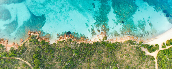 Wall Mural - View from above, stunning aerial view of a green and rocky coastline bathed by a turquoise, crystal clear water. Liscia Ruja, Costa Smeralda, Sardinia, Italy..