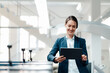© Westend61 - Female business professional using digital tablet in industry