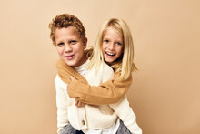 Boy And Girl Together In Sweaters Fun Casual Wear Beige Background