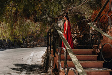 Woman In Little Red Riding Hood Costume Standing By Railing