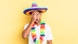 hispanic handsome man looking shocked, scared or terrified, covering face with hand. mexican party concept