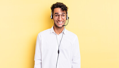 Wall Mural - hispanic handsome man looking happy and pleasantly surprised. telemarketer concept