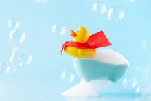 Rubber Yellow Duck In Red Cloak On A Bath Of Foam. Spa Concept. Global Handwashing Day