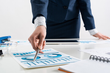 Wall Mural - Businesswoman standing near office desk with pen