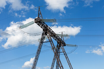 high voltage power transmission tower. electrical insulators against the blue sky.