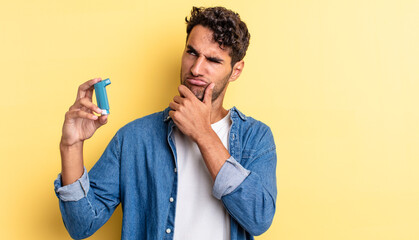 Wall Mural - hispanic handsome man thinking, feeling doubtful and confused. asthma concept