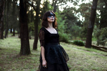 Witch In Black Dress In Dark Forest