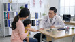 © PRPicturesProduction - asian pediatrician is observing the young child and asking the mother questions during the appointment in his clinic office.