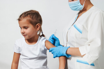 Wall Mural - Female doctor injecting vaccine to girl