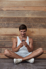 Sticker - Young european man sitting and using mobile phone