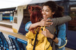 © Drobot Dean - Multiracial two women hugging while saying goodbye at train station