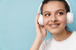 © Drobot Dean - Young woman smiling while listening music with headphones