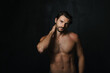 © Drobot Dean - Young half-naked man posing and looking at camera