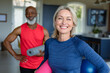 © Wavebreak Media - Portrait of happy senior diverse couple in exercise clothes practicing yoga, looking at camera