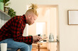 © Wavebreak Media - Albino african american man with dreadlocks working from home and using tablet