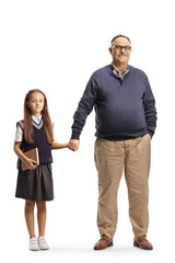 Wall Mural - Full length portrait of a schoolgirl holding hands with grandfather