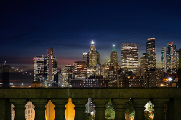 Sticker - View of lower Manhattan and Financial district at night. Skyscrapers with lights on in New York City seen above columns of Manhattan Bridge